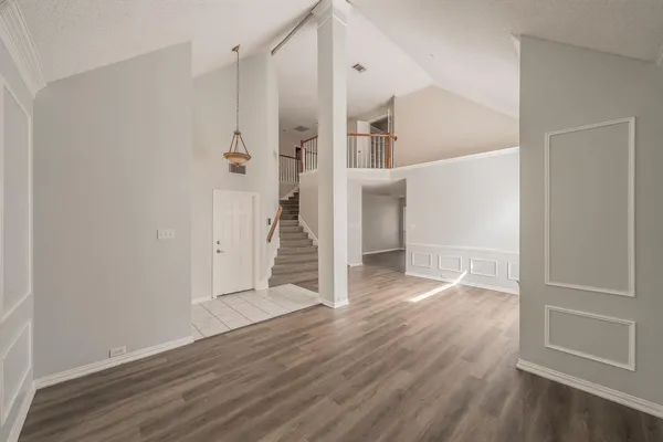 an empty room with wooden floor