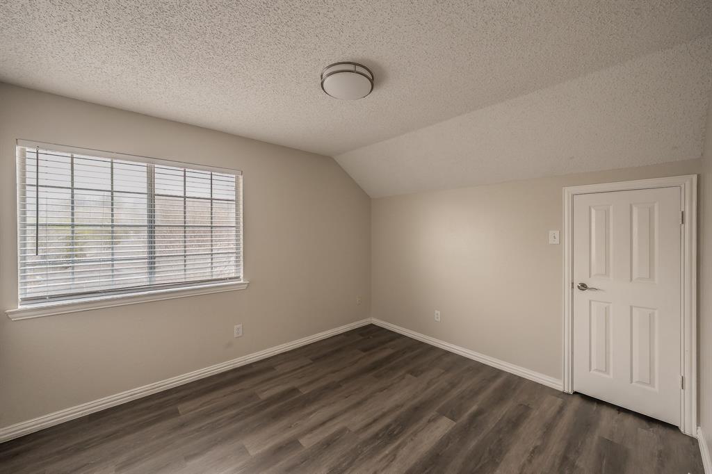 2643 Garden Ridge Lane Arlington, TX 76006 - Photo 35 of 40 an empty room with wooden floor and windows