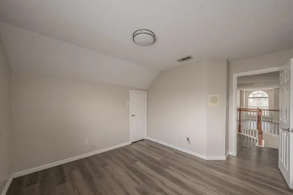 a view of a livingroom with wooden floor and a couch