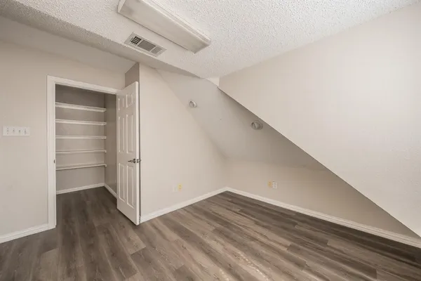 a view of walk in closet with empty racks