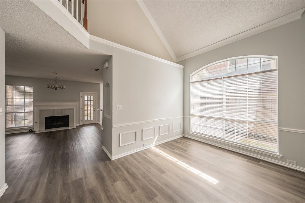 2643 Garden Ridge Lane Arlington, TX 76006 - Photo 6 of 40 an empty room with wooden floor fireplace and windows