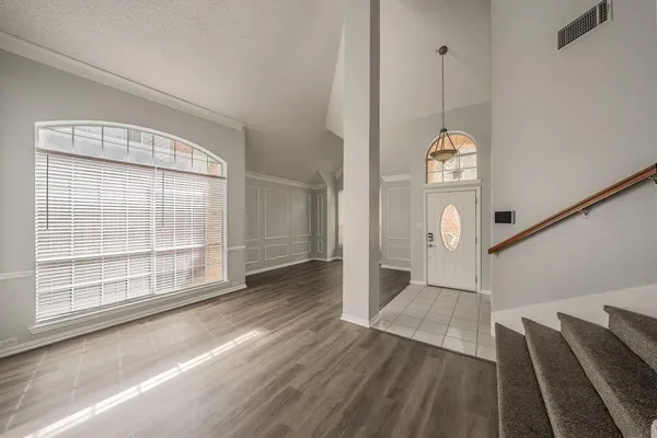 a view of wooden floor and windows in a room