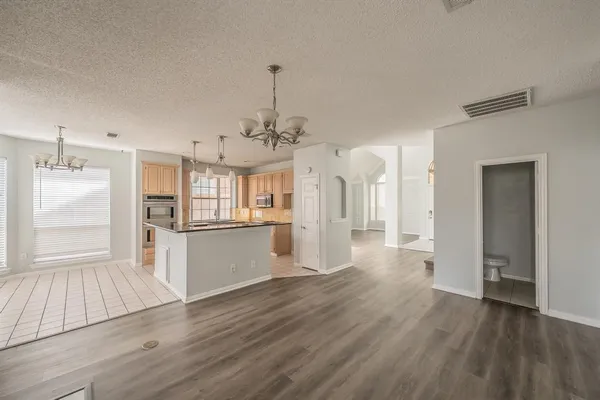 a view of a kitchen with a sink and wooden floor
