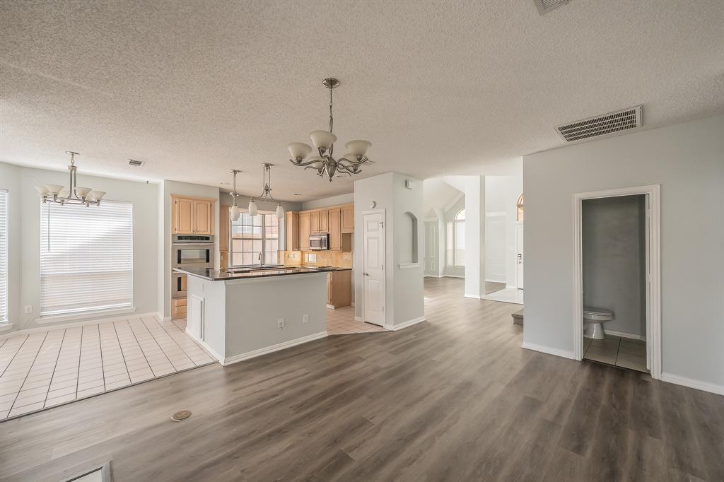 2643 Garden Ridge Lane Arlington, TX 76006 - Photo 9 of 40 a view of a kitchen with a sink and wooden floor