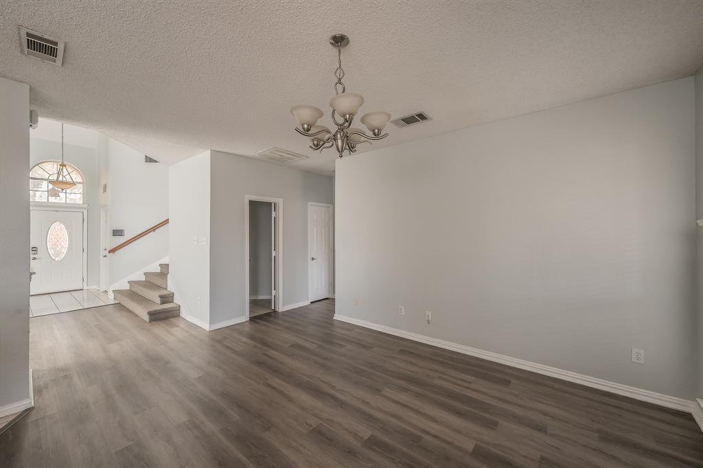2643 Garden Ridge Lane Arlington, TX 76006 - Photo 10 of 40 wooden floor in an empty room with a window
