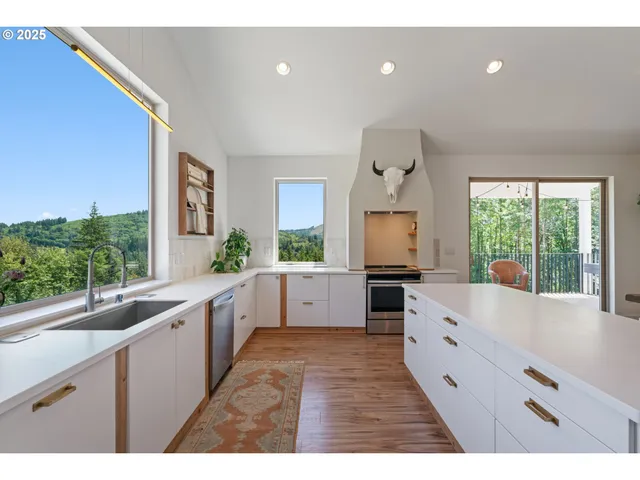 a large kitchen with granite countertop a large counter top and sink