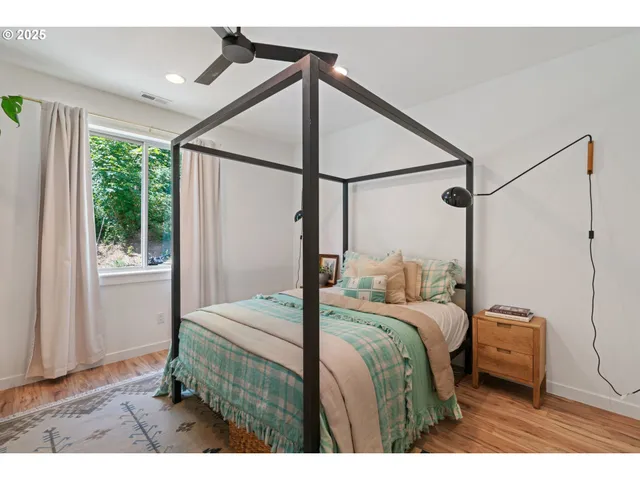 a bedroom with a bed window and a shower