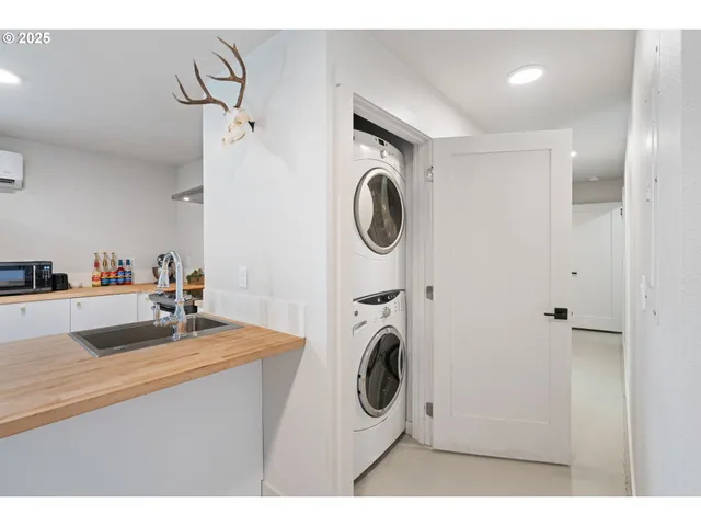 a bathroom with a sink a washer and dryer