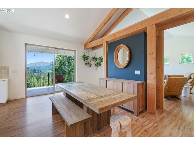a view of a room with furniture and wooden floor