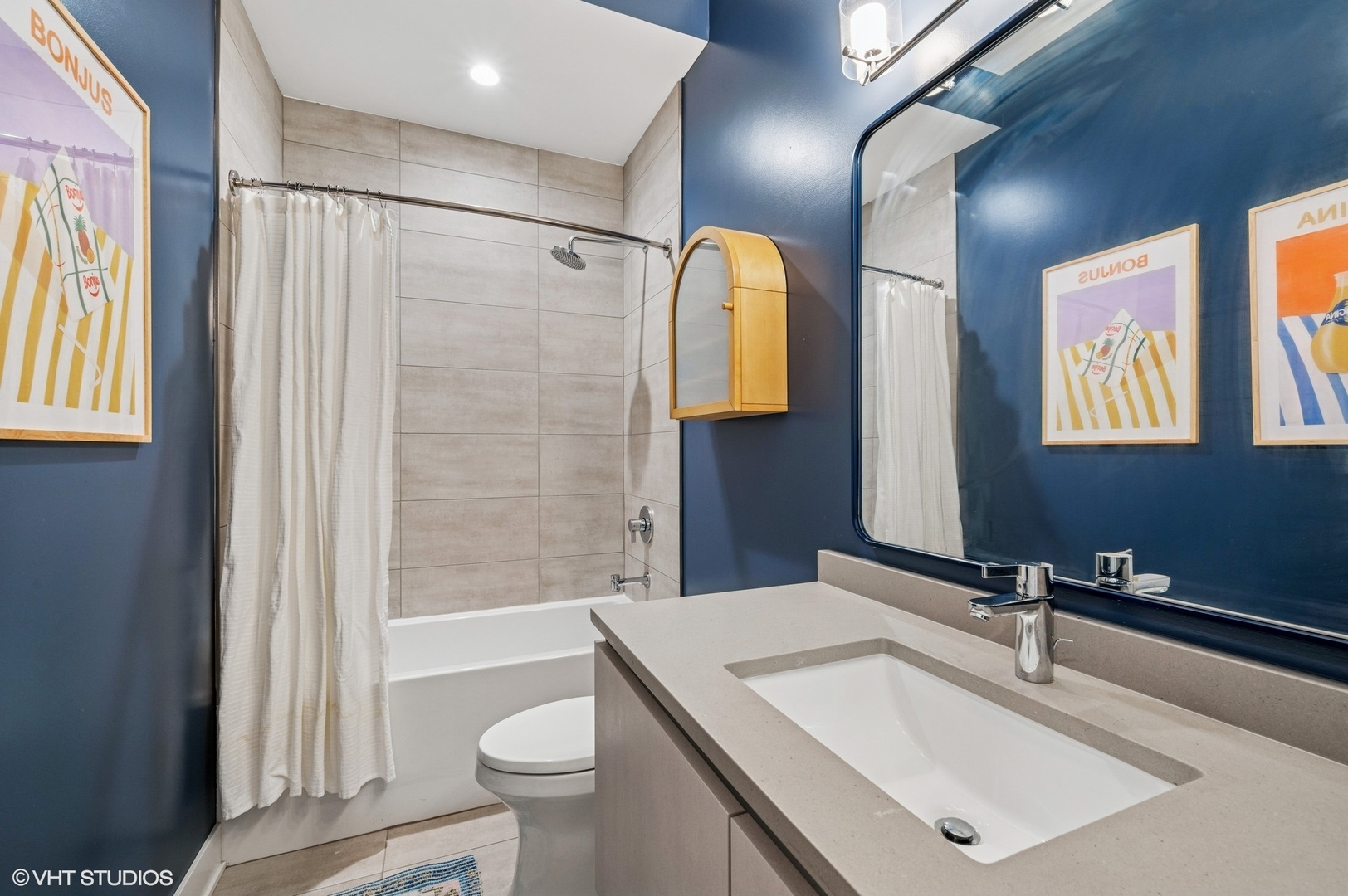 1156 West Ohio Street, Unit 2E Chicago, IL 60642 - Photo 24 of 30 a bathroom with a sink a toilet a mirror and shower