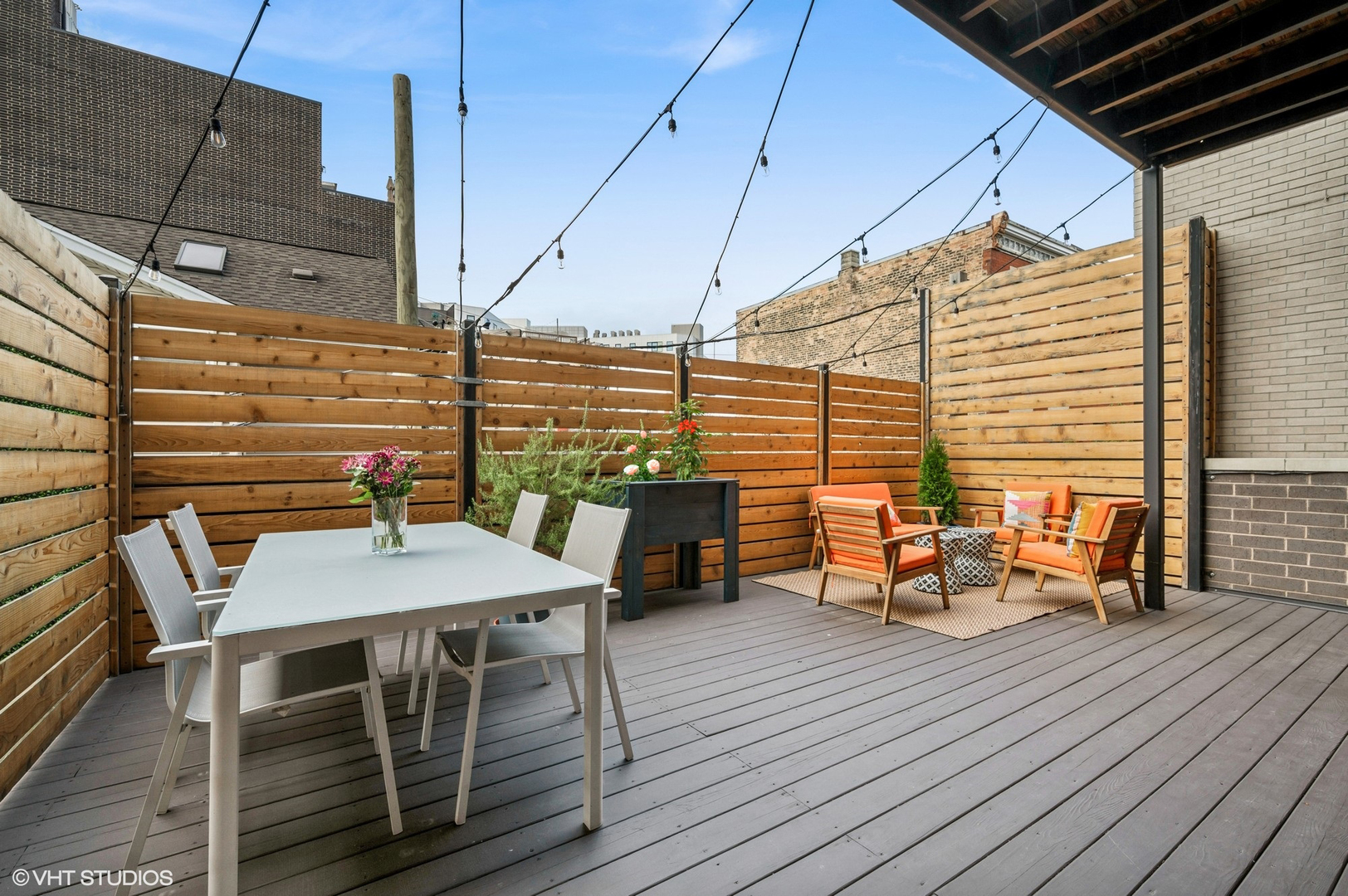 1156 West Ohio Street, Unit 2E Chicago, IL 60642 - Photo 27 of 30 a view of a roof deck with table and chairs with wooden floor