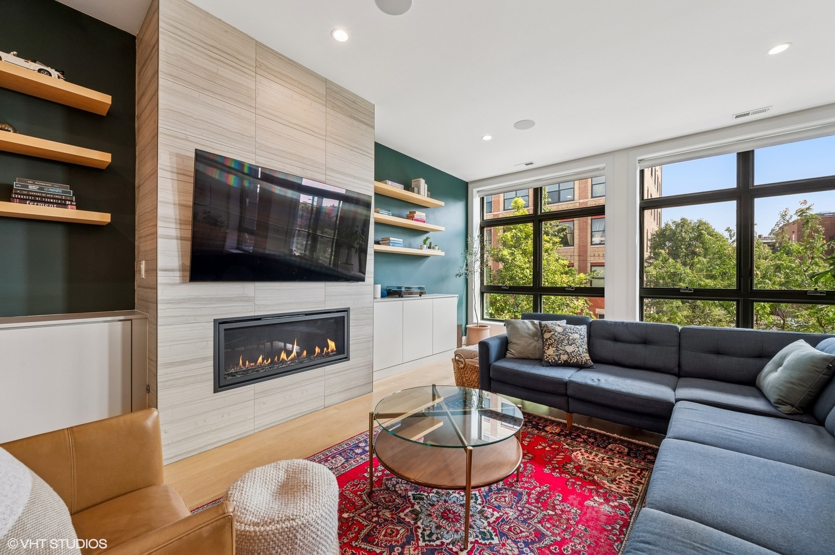1156 West Ohio Street, Unit 2E Chicago, IL 60642 - Photo 4 of 30 a living room with furniture a flat screen tv and a fireplace