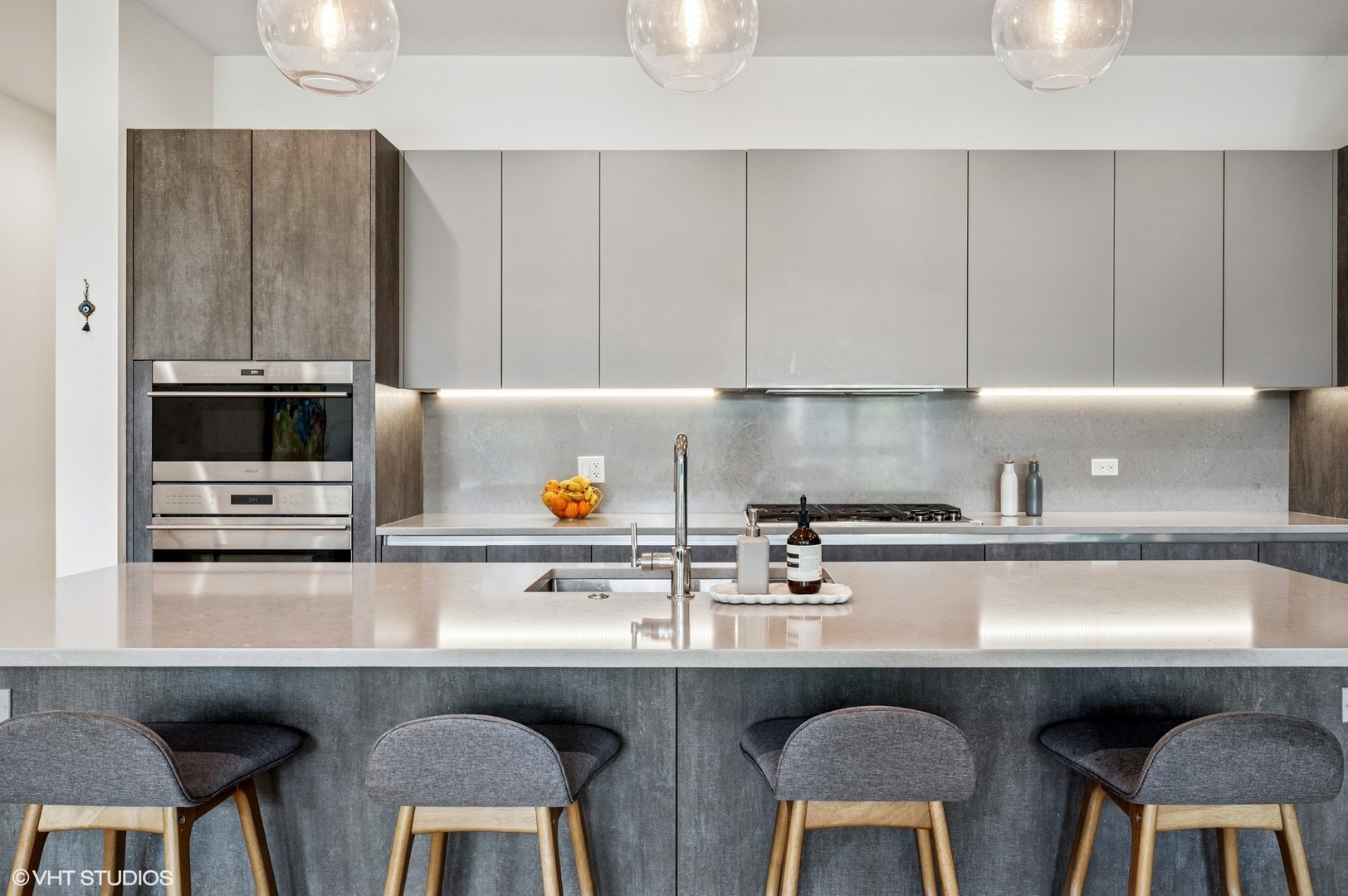 1156 West Ohio Street, Unit 2E Chicago, IL 60642 - Photo 10 of 30 a kitchen with stainless steel appliances a sink a stove a table and chairs