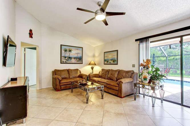 22682 Pickerel Circle Boca Raton, FL 33428 - Photo 13 of 20 a living room with furniture and a large window