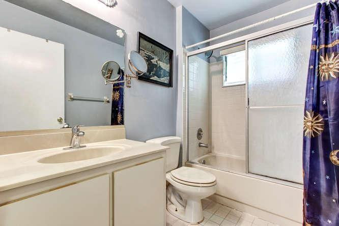 22682 Pickerel Circle Boca Raton, FL 33428 - Photo 19 of 20 a bathroom with a toilet a sink and a large mirror
