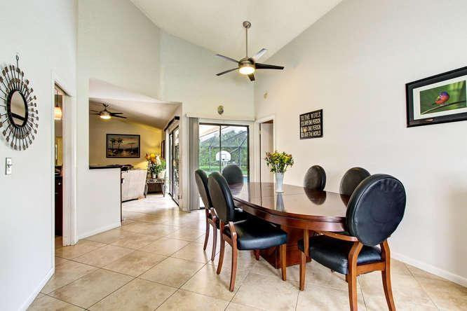 22682 Pickerel Circle Boca Raton, FL 33428 - Photo 7 of 20 a view of a dining room with furniture and a chandelier