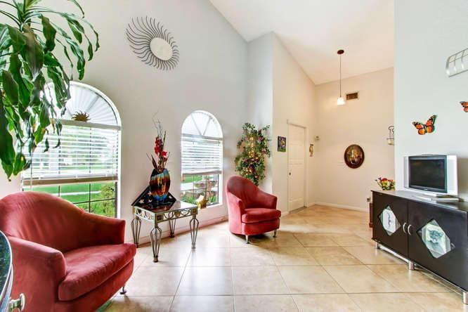 22682 Pickerel Circle Boca Raton, FL 33428 - Photo 9 of 20 a living room with furniture a rug potted plant and a window