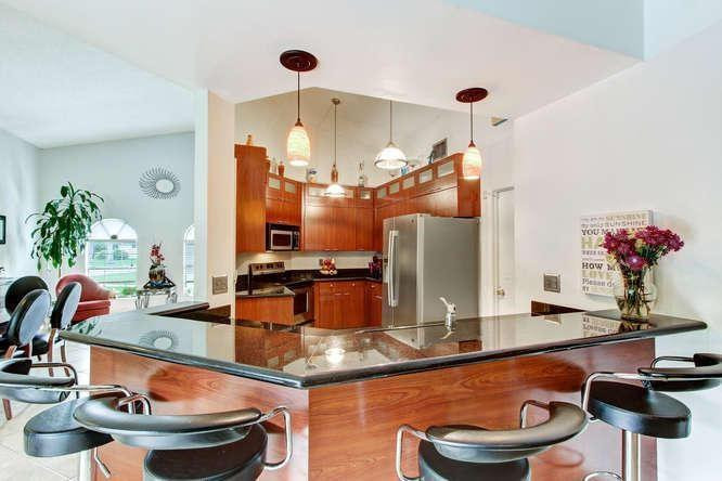 22682 Pickerel Circle Boca Raton, FL 33428 - Photo 10 of 20 a room with table and chairs