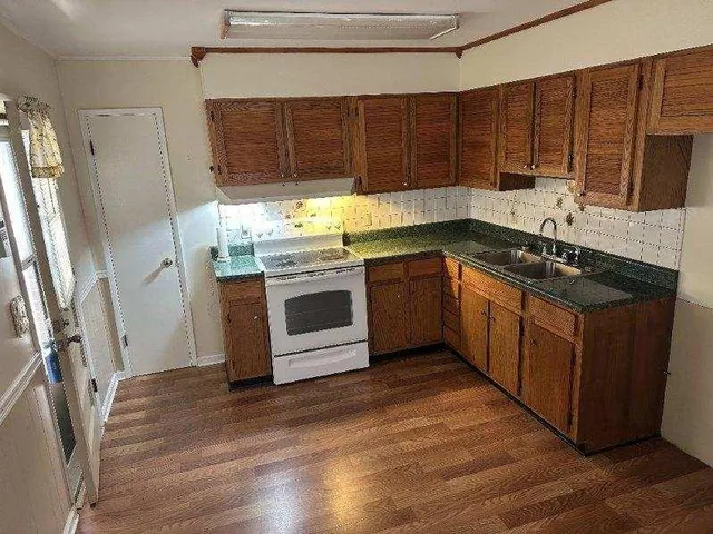 a kitchen with stainless steel appliances granite countertop a stove a sink dishwasher and a refrigerator