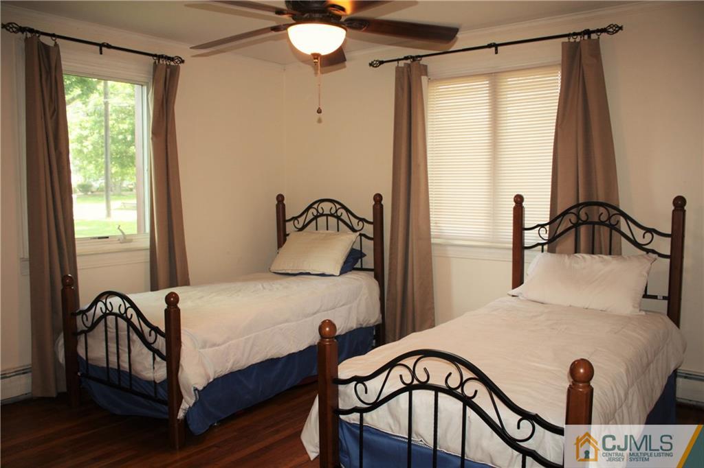 595 Old Post Road Edison, NJ 08817 - Photo 11 of 19 a bedroom with a bed and wooden floor