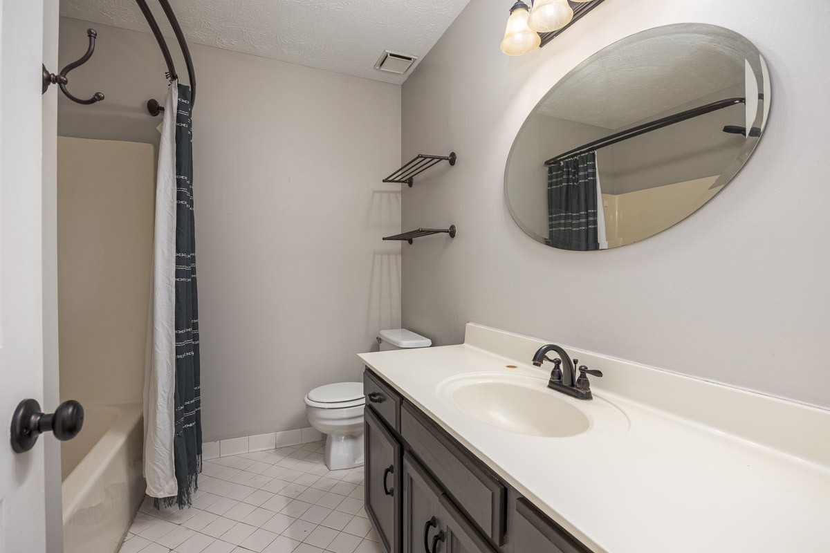 5916 Retriever Court Antioch, TN 37013 - Photo 25 of 30 a bathroom with a sink and mirror with toilet