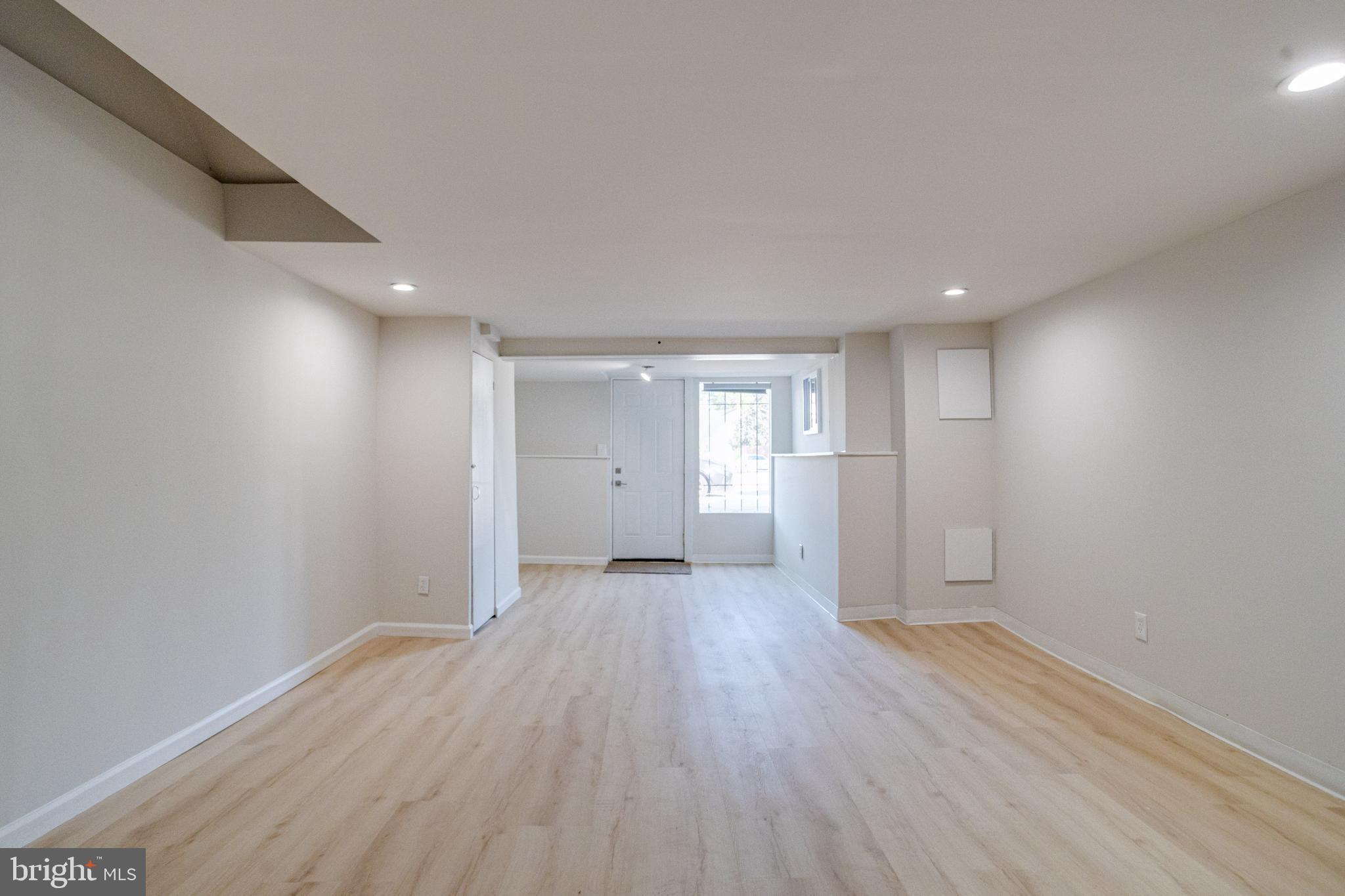 5878 Belair Road Baltimore, MD 21206 - Photo 36 of 41 wooden floor in an empty room with a window