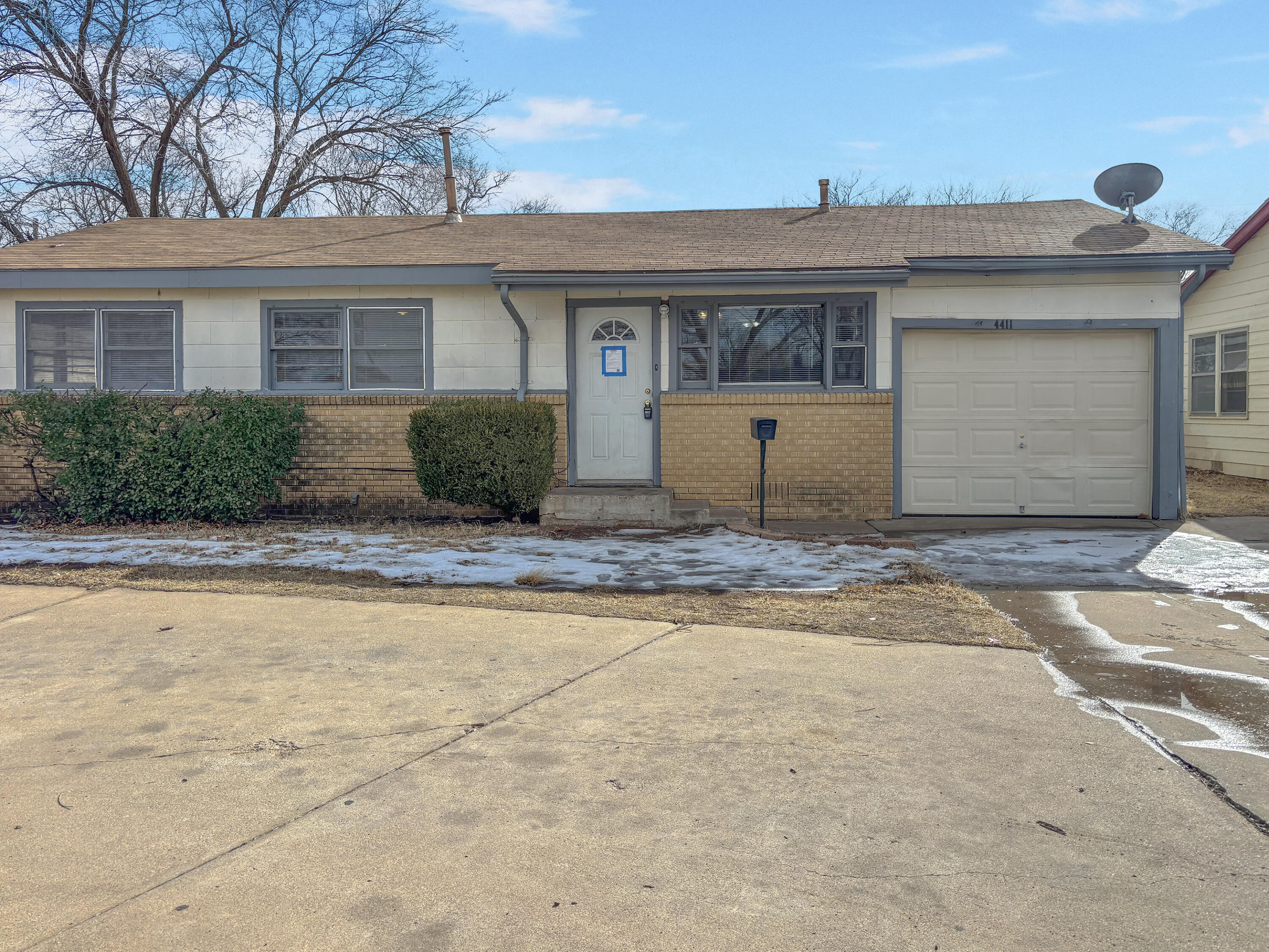 4411 45th Street Lubbock, TX 79414 - Photo 2 of 44 a front view of a house with a yard