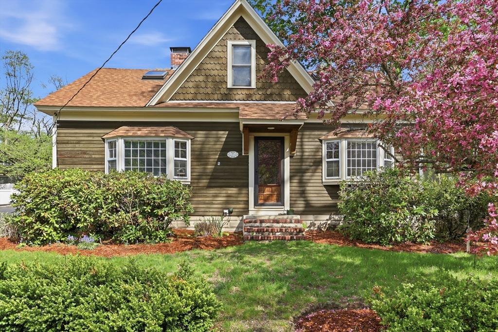 80 Concord Street Maynard, MA 01754 - Photo 1 of 29 a front view of a house with a garden