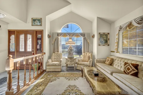 a view of a backyard with couches plants and large tree