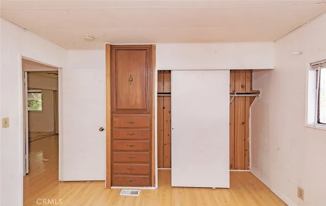 a view of a house with wooden fence
