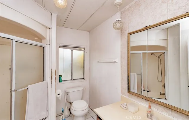 a room with wooden floor pool table and windows