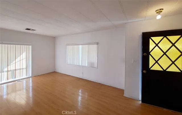 a view of a room with wooden floor and stairs