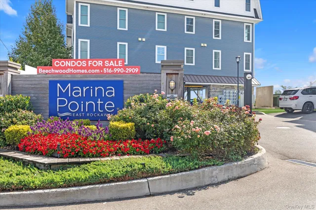 a sign that is sitting in front of flowers