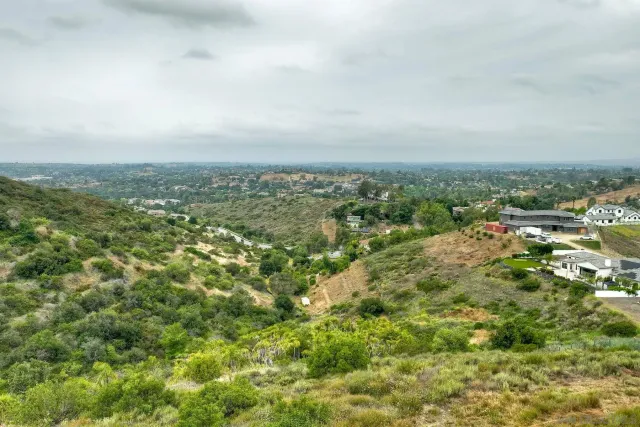 an aerial view of residential houses with city view