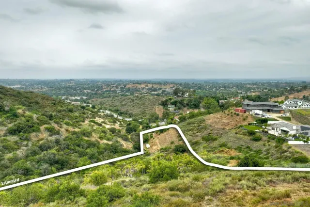 an aerial view of a residential houses with city view