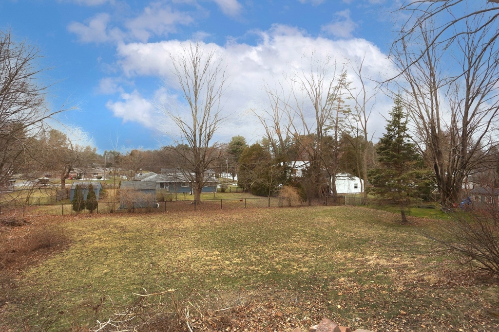 151 Turnpike Road Chelmsford, MA 01824 - Photo 6 of 21 a view of a yard with a house