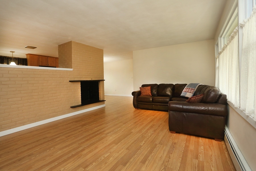 151 Turnpike Road Chelmsford, MA 01824 - Photo 8 of 21 a living room with furniture and a fireplace