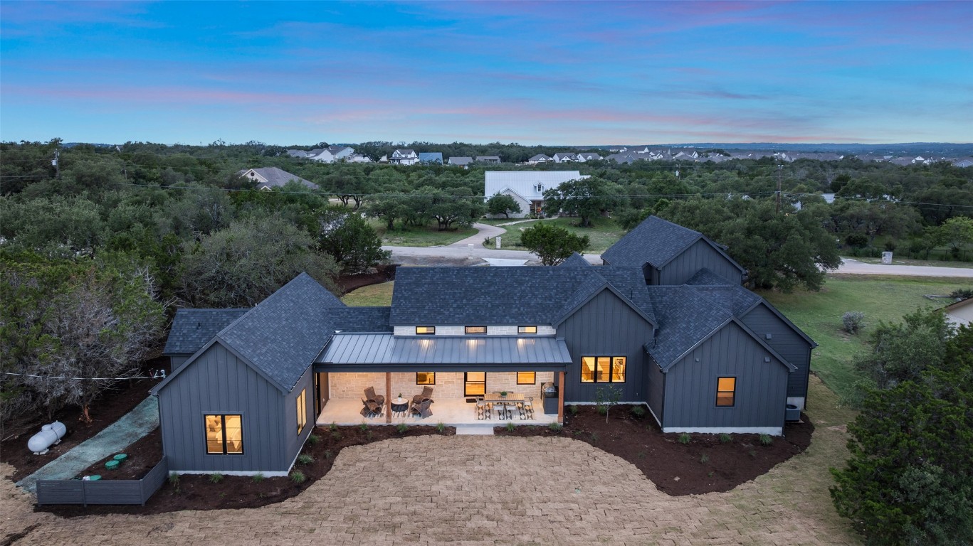 an aerial view of a house with a yard