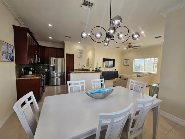 a kitchen with a dining table and chairs