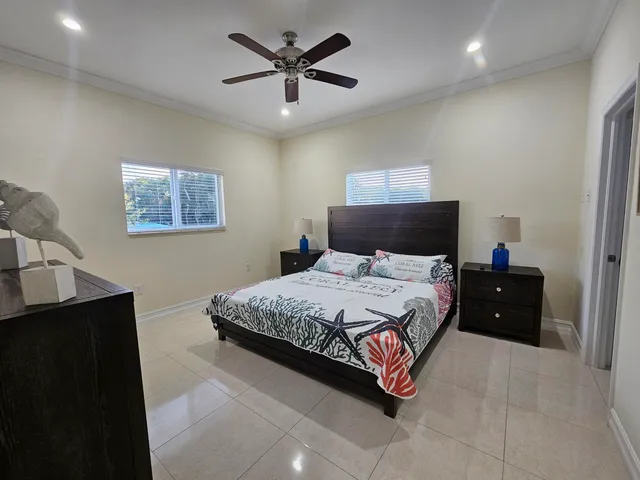 a bedroom with a bed and a lamp on dresser