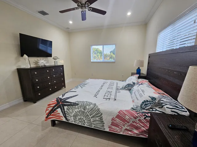 a bedroom with a bed and a flat screen tv