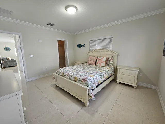 a bedroom with a bed and lamp with window