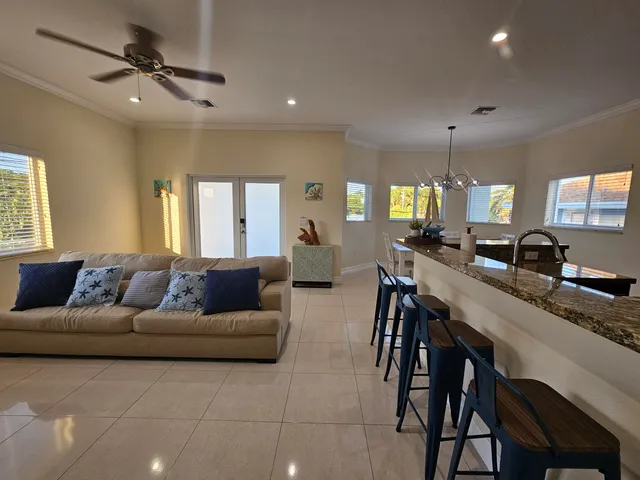 a living room with furniture kitchen and a chandelier