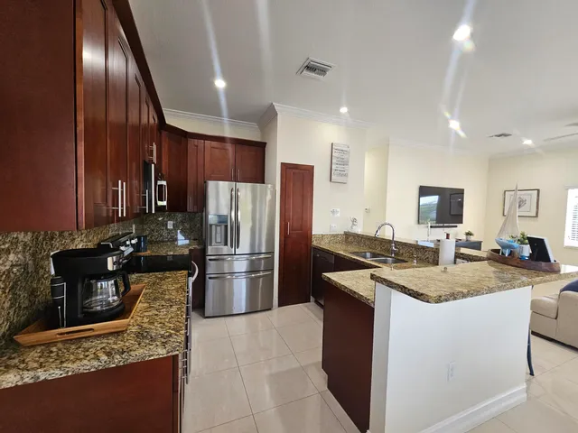 a kitchen with a refrigerator sink and stove