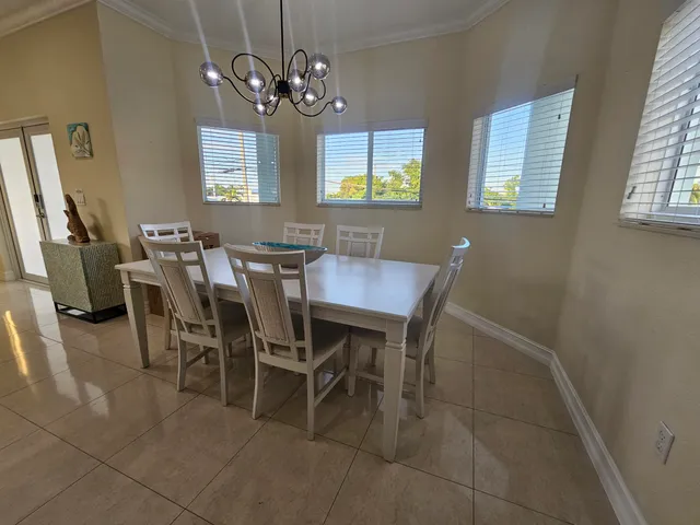 a view of a dining room with furniture and chandelier