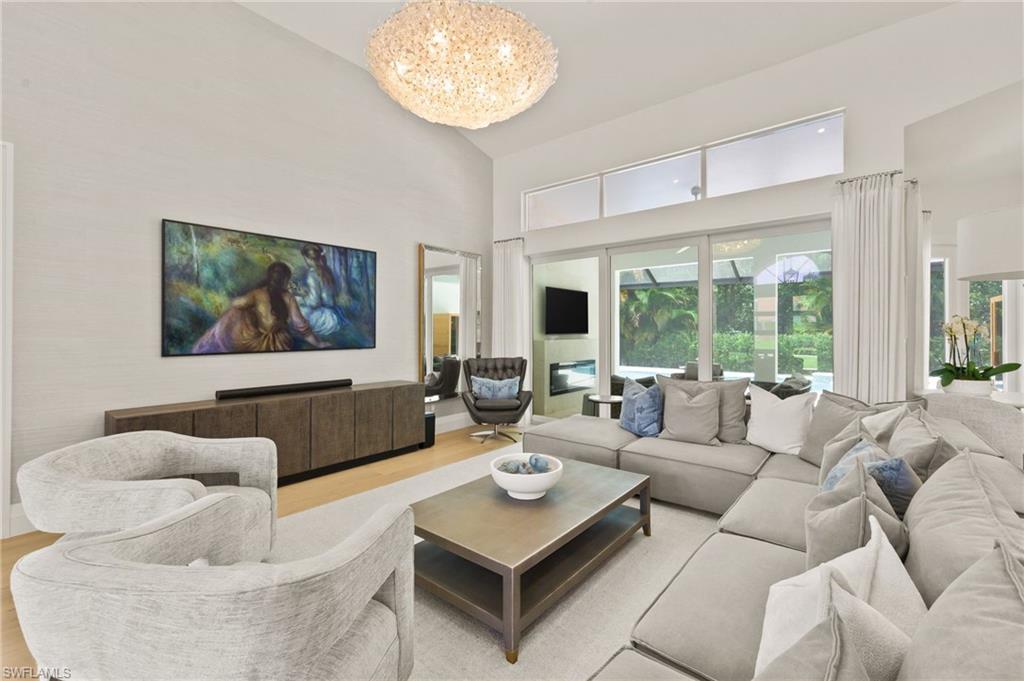 6689 Mill Run Road Naples, FL 34109 - Photo 11 of 37 a living room with furniture and a large window