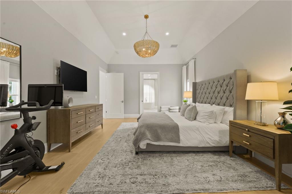 6689 Mill Run Road Naples, FL 34109 - Photo 21 of 37 a bedroom with furniture and a flat screen tv