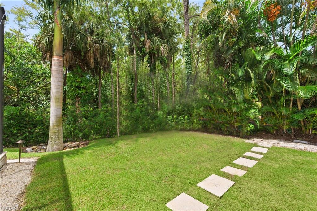 6689 Mill Run Road Naples, FL 34109 - Photo 28 of 37 a view of a backyard with a garden
