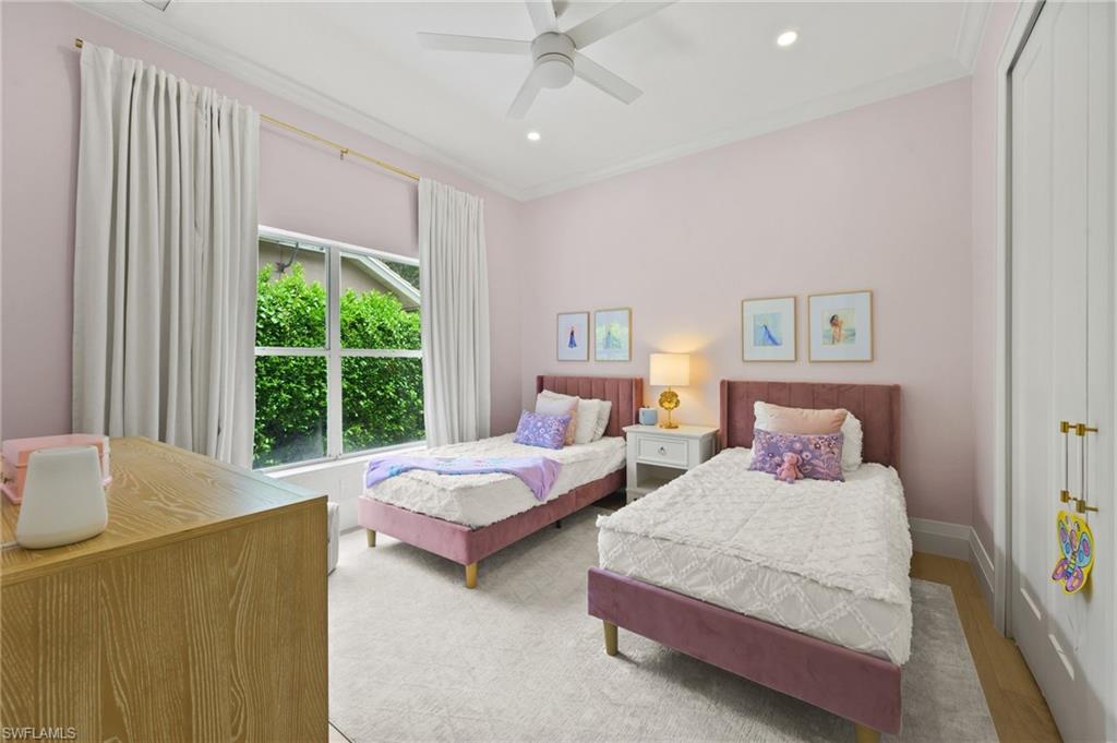 6689 Mill Run Road Naples, FL 34109 - Photo 30 of 37 a spacious bedroom with two beds and large window