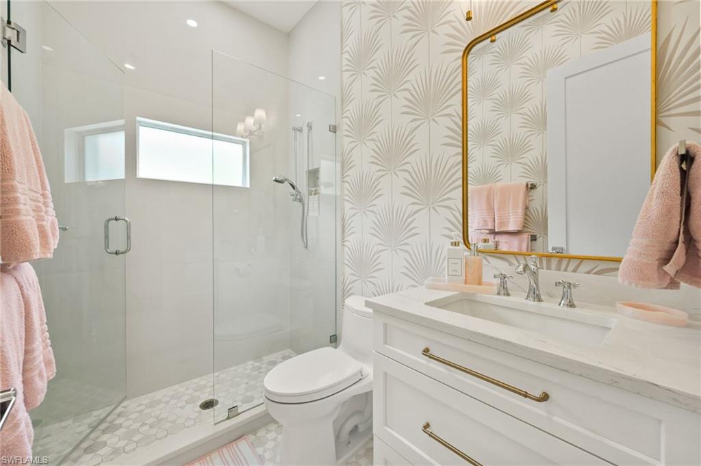 6689 Mill Run Road Naples, FL 34109 - Photo 31 of 37 a bathroom with a sink a toilet and shower